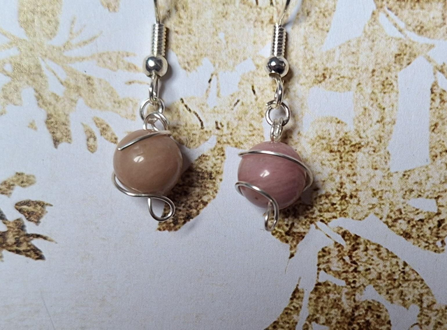 Planetary lovers set in silver with Rhodonite