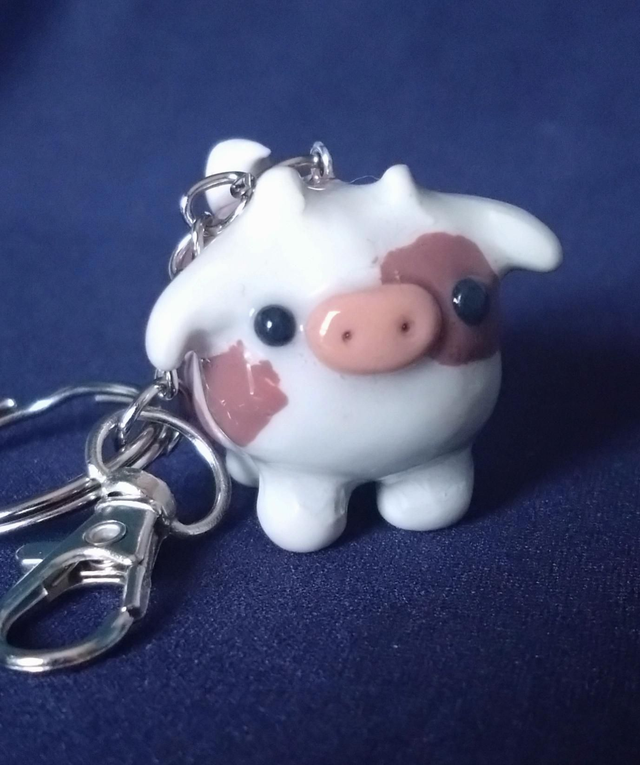 Brown and white cow clay charm