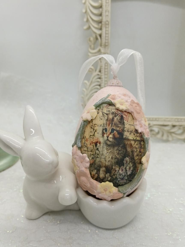 Kitten on a hanging Goose egg 