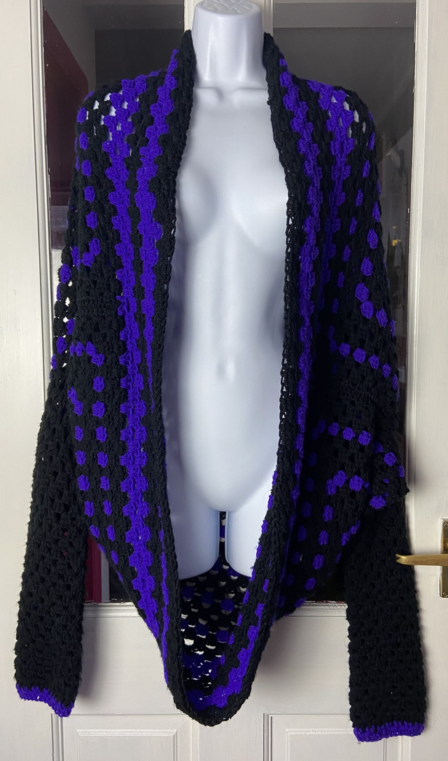 Purple and black shrug style cardigan.